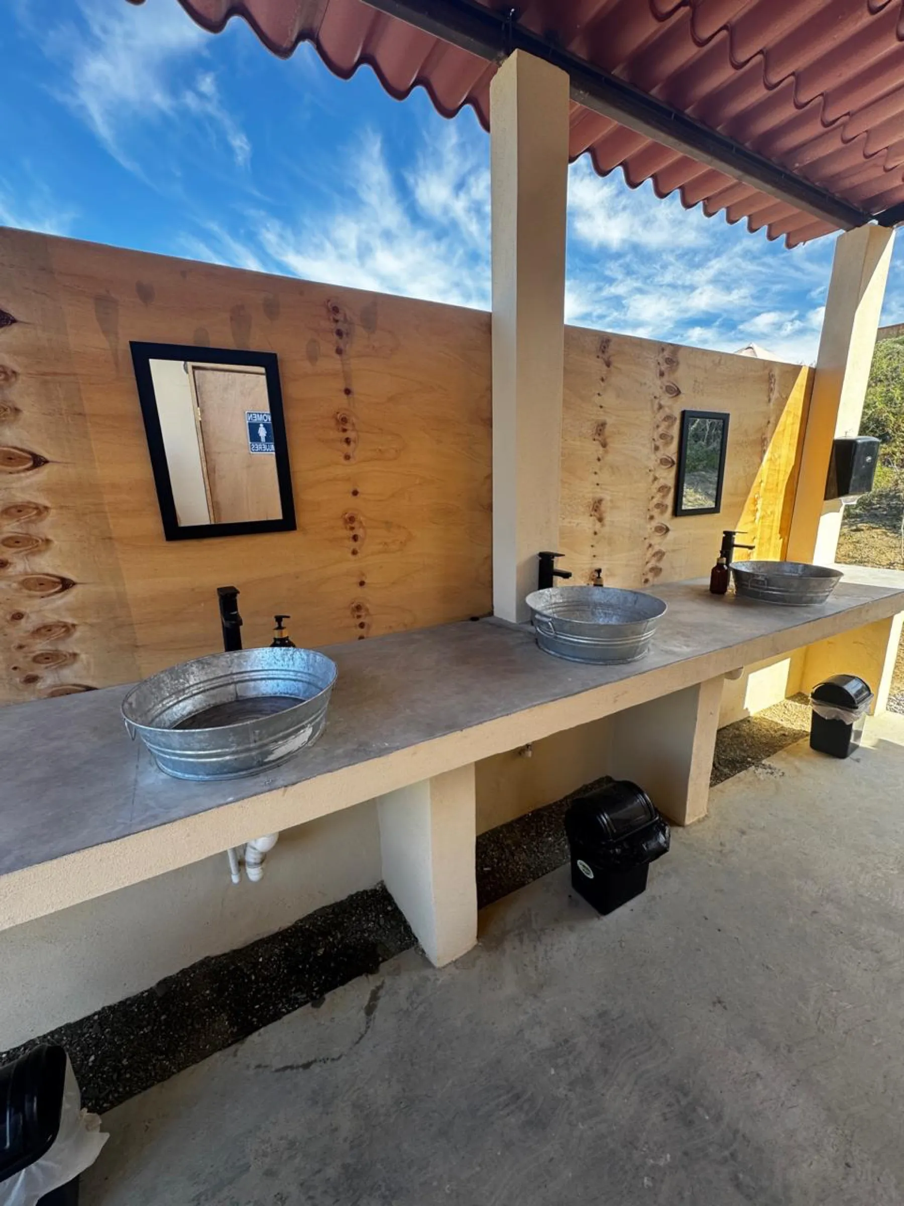 Open-air washbasins at camp
