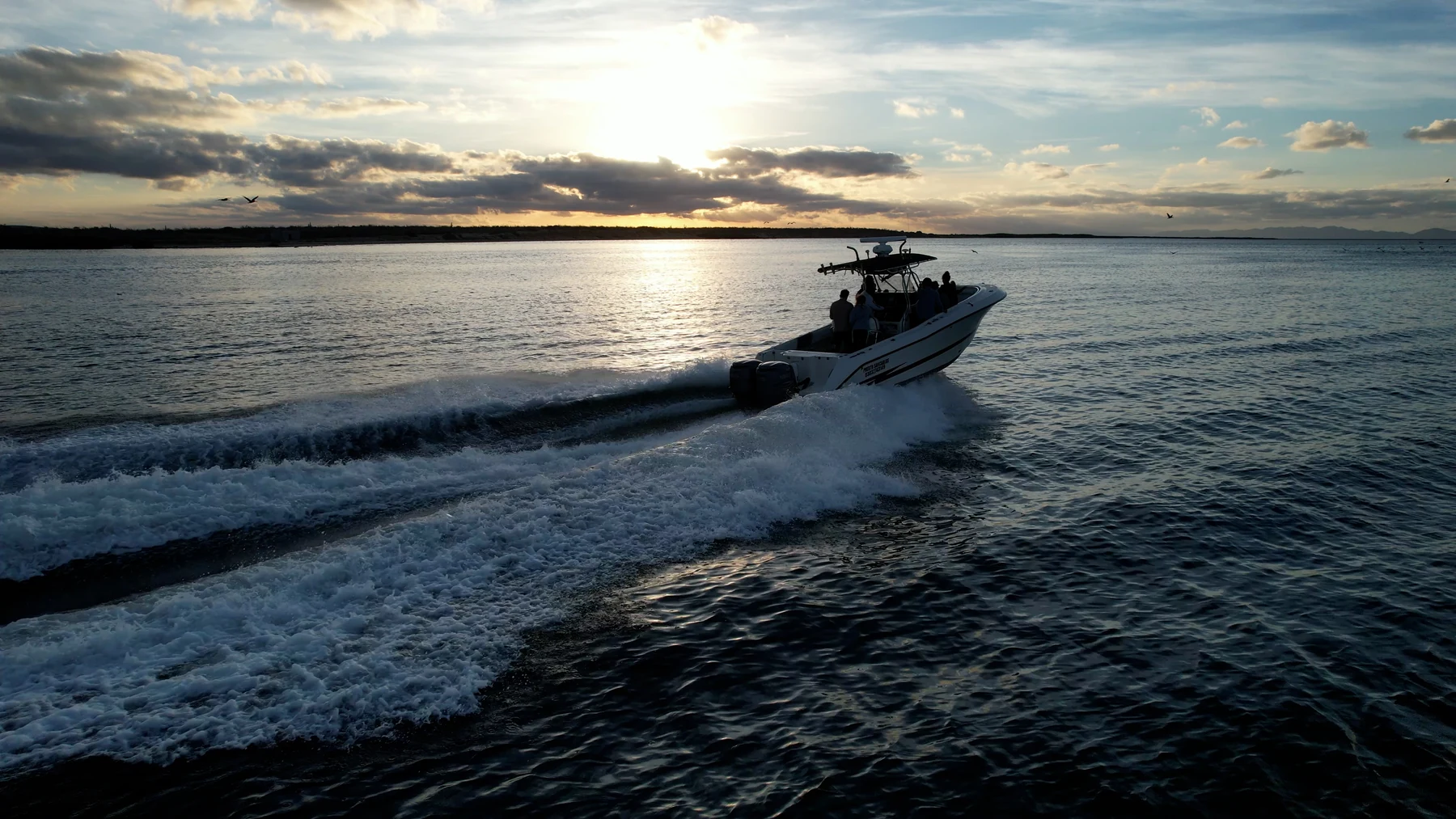 A panga crossing Magdalena Bay at sunset